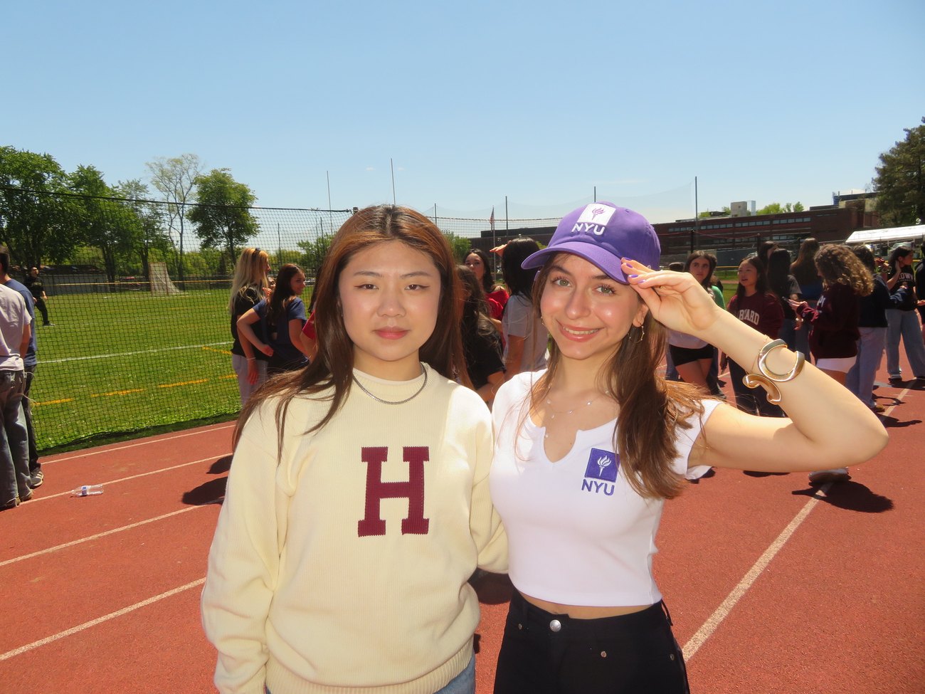 Claire Jiang in a Harvard sweater with a friend on commitment day