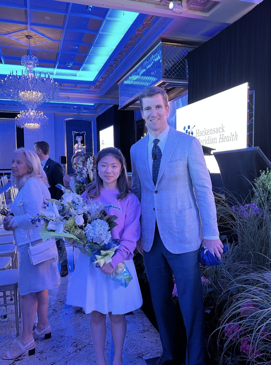 Claire Jiang with Eli Manning at a Hackensack Meridian Health event