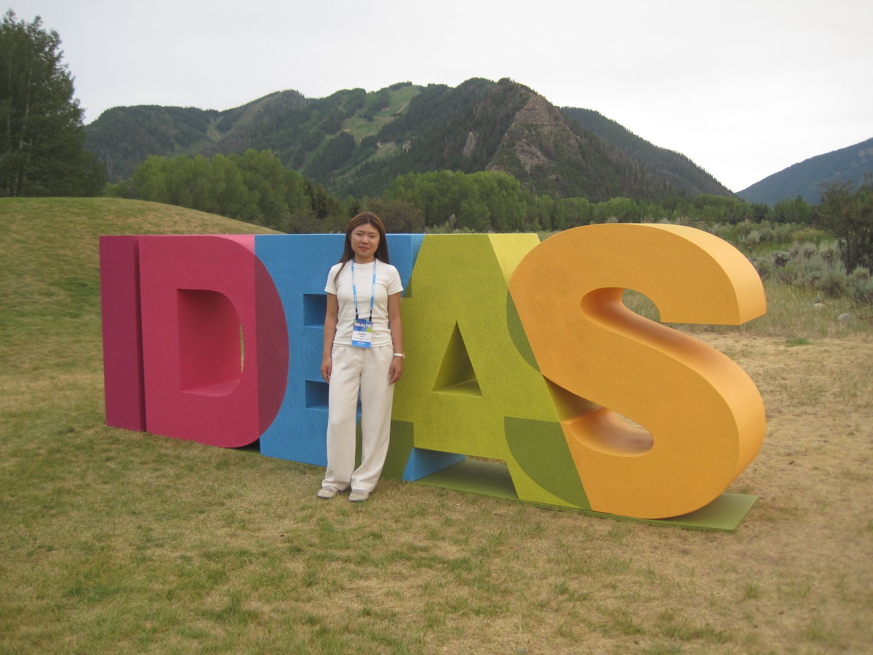 Claire Jiang beside the Aspen Ideas sign on the Aspen Institute campus